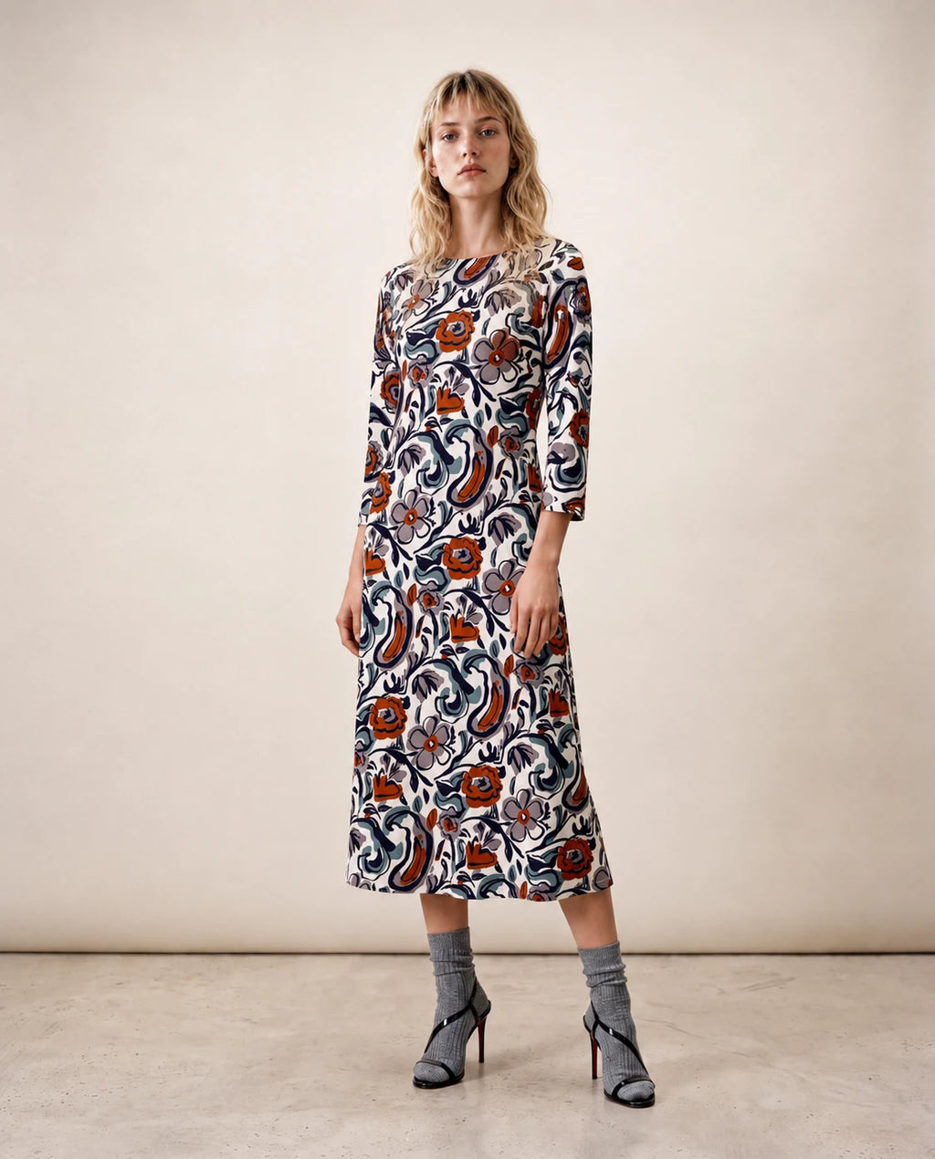 Vestido midi estampado con manga tres cuartos y cuello redondo, base clara con flores y remolinos